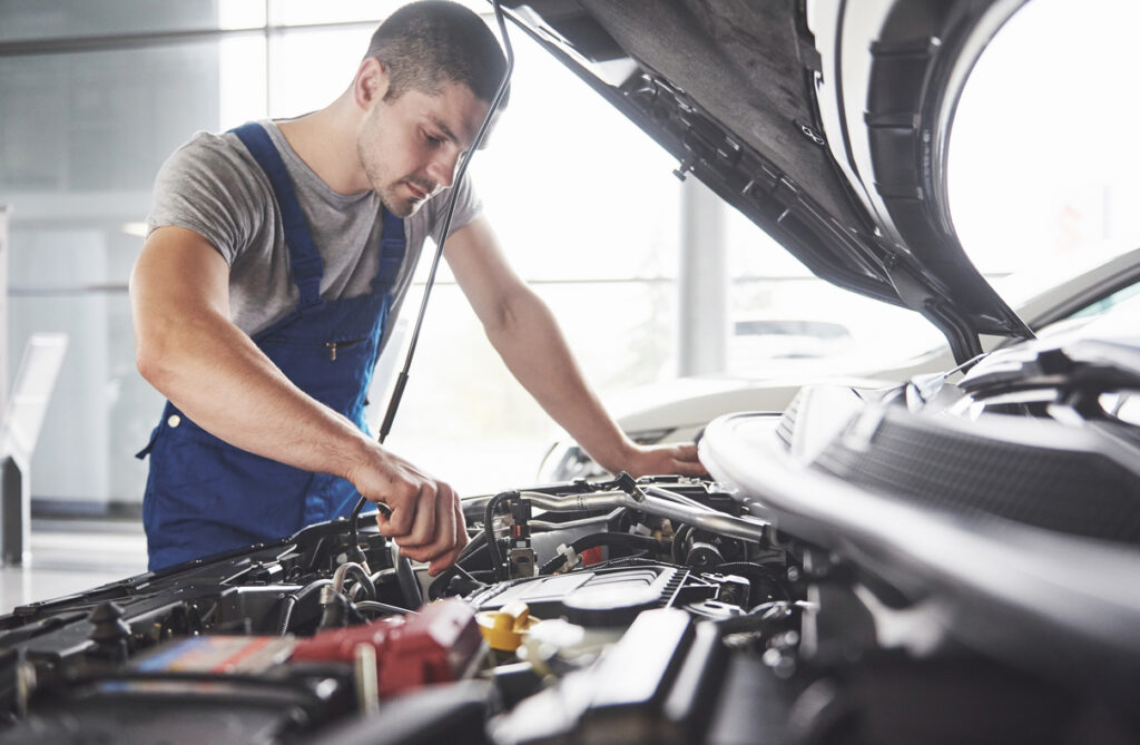 a man check car engine