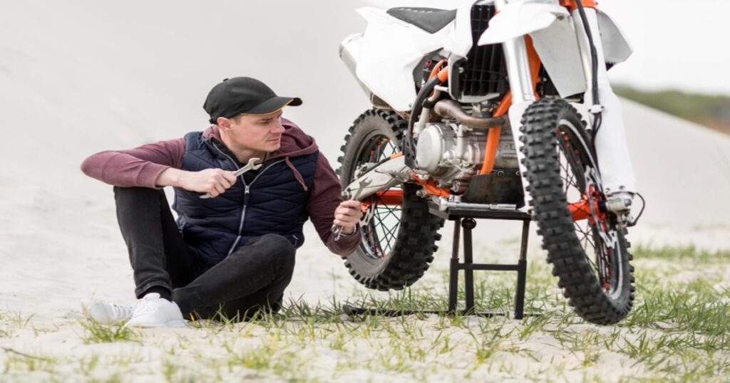 Adult Man Repair His Dirt Bike 