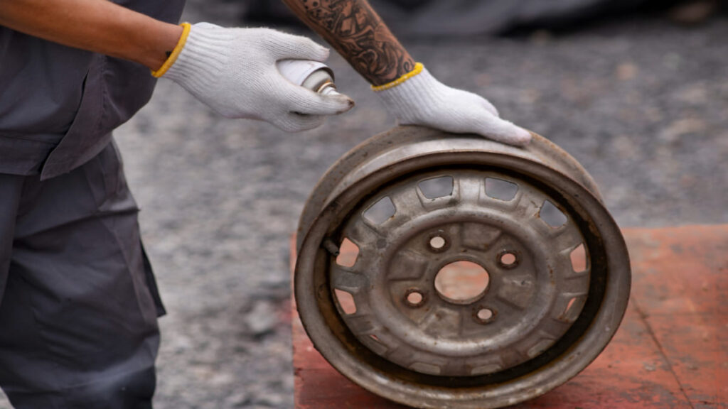 a man cleaning car greasy wheels